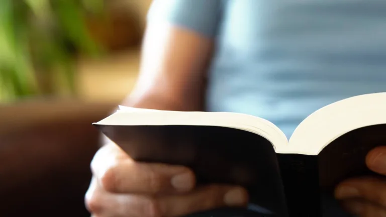 man holding open Bible